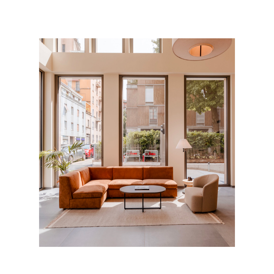 Foto di showroom Former In con divano arancione sedie e poltrona color panna